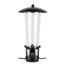 Load image into Gallery viewer, Perky-Pet Squirrel-Be-Gone Max Bird Feeder featuring a rustic bronze metal housing and a clear seed reservoir. The design includes four feeding stations with ladder-style perches and a weight-activated Seed Shield that slides down to cover the ports.